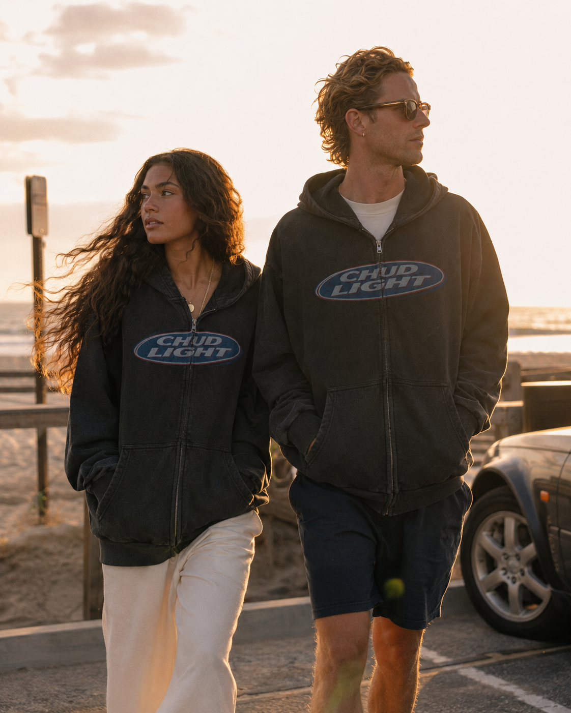 Two models wearing the Chud Light Hoodie at sunset