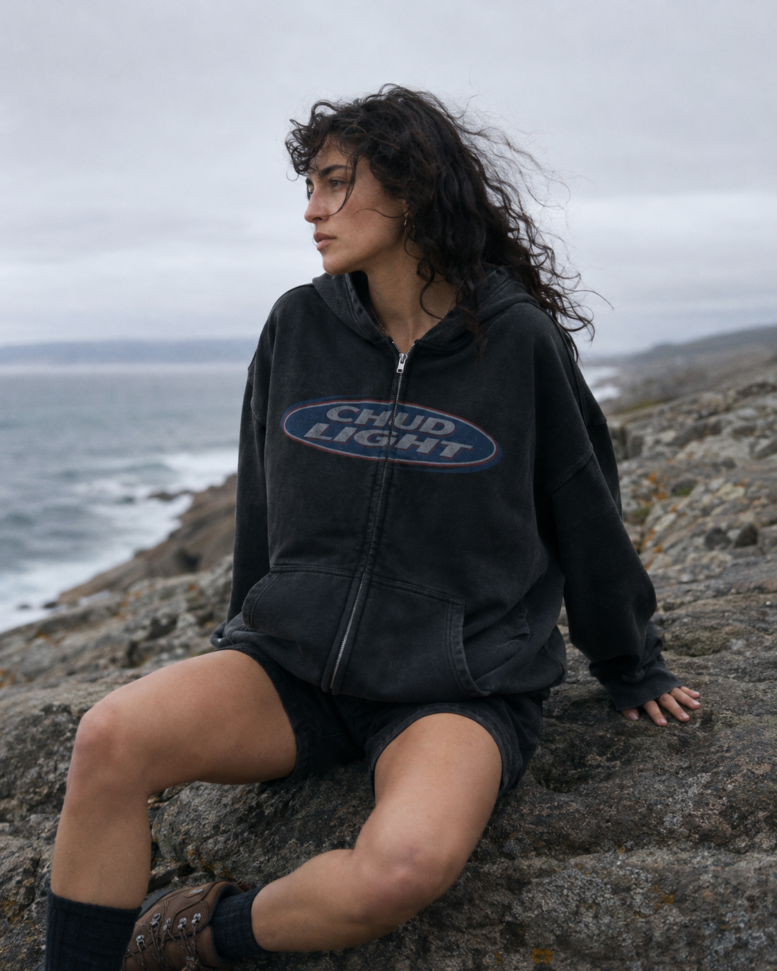 Model wearing the Chud Light Hoodie by the coast