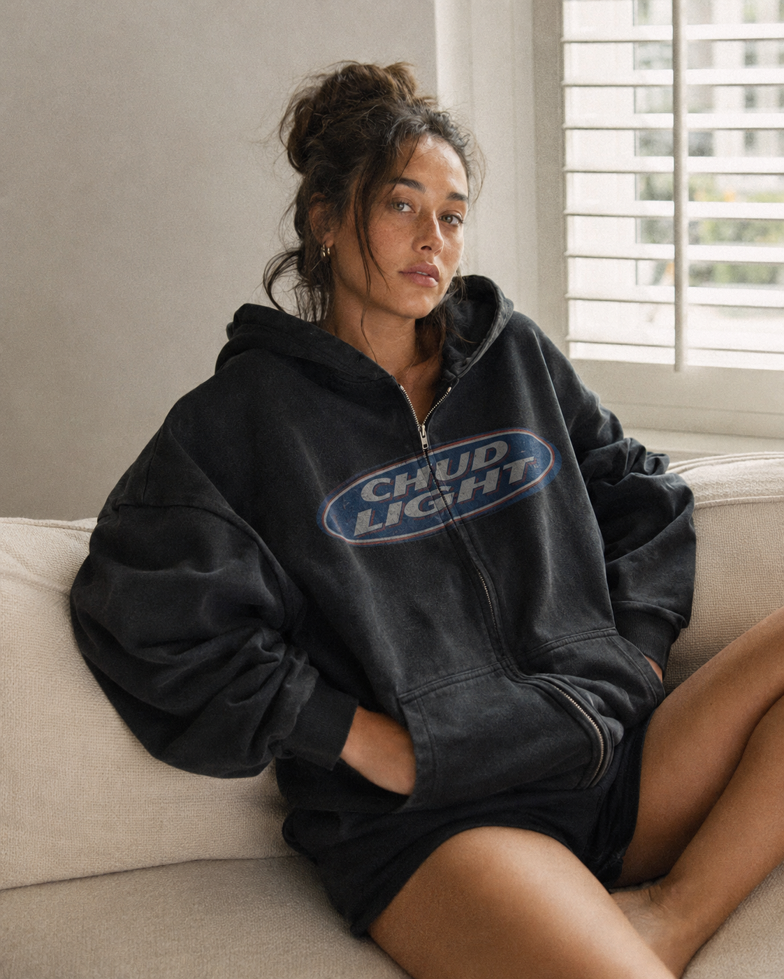 Model wearing the Chud Light Hoodie indoors